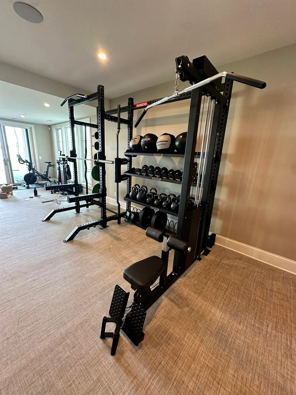 Rack-mounted cable tower with lat pulldown seat, the kind of equipment AFS services and repairs